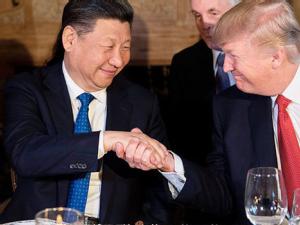 https://www.ajot.com/images/uploads/article/Donald-Trump-Xi-Jinping-handshake-Florida.jpeg