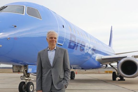 David Neeleman in front of a Breeze Airways Embraer SA E190
