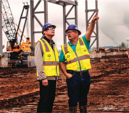 Mark Bula, left, chief commercial officer at Big River Steel, is joined by construction team member John Elinburg at the 1,300-acre Arkansas site on the Mississippi River where the company is building a huge mill.
