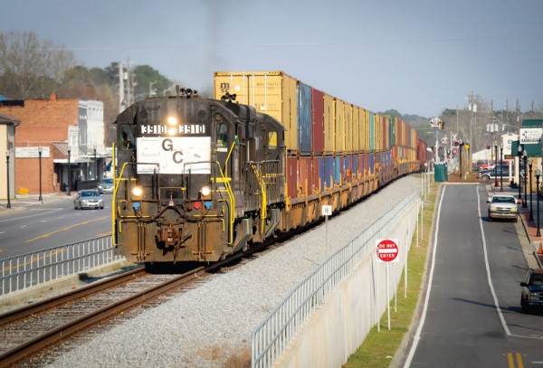 A train of short line Georgia Central Railway carries double-stacked containers through Claxton, Georgia, on its way from the Port of Savannah to the Cordele Inland Port.