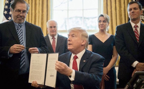 President Trump shows off a signed executive order.