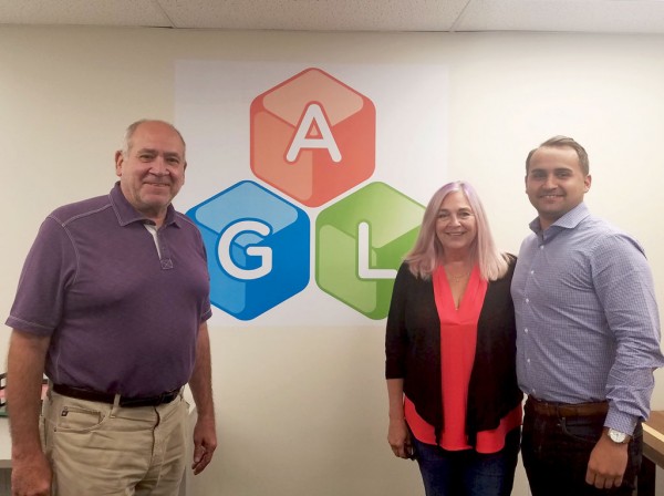 teve Zambo, left, president of Ally Global Logistics LLC, discusses lumber and log exports with Cindra Zambo, the company’s chief financial officer, and Stephen Zambo, vice president.
