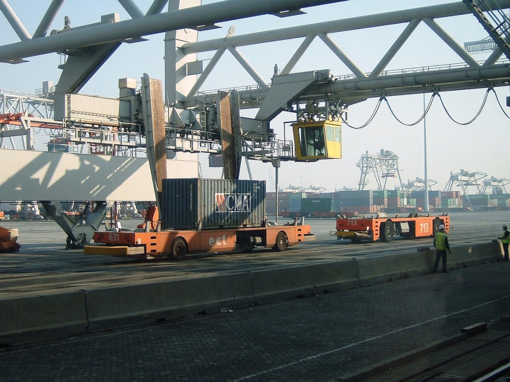 Container terminals showing a container being loaded onto an unmanned automated guided vehicle.
