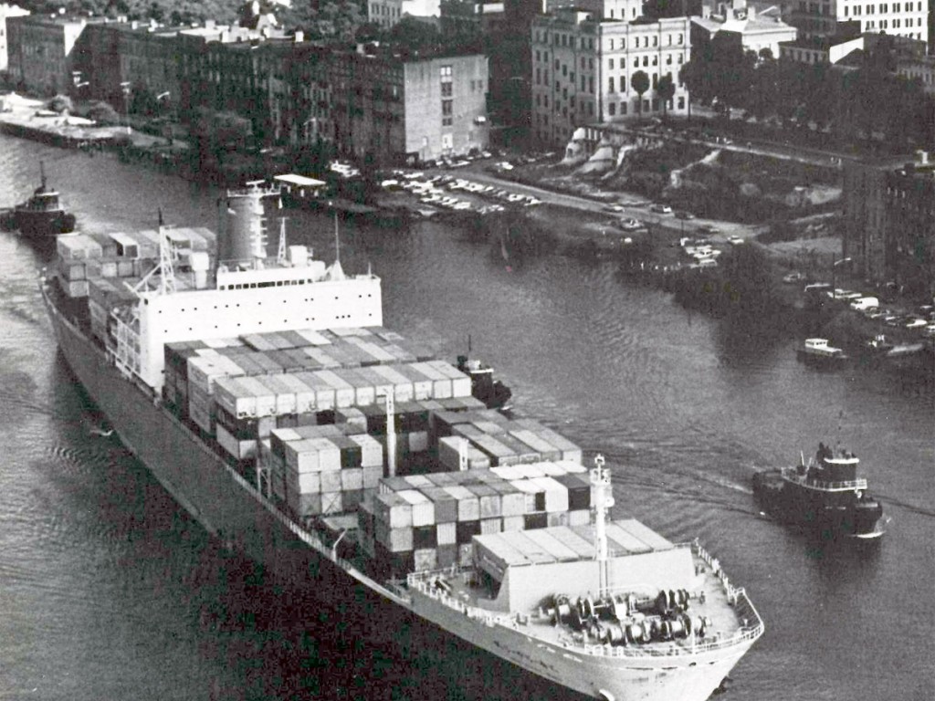 A containership with boxes loaded 12 wide makes its way past downtown Savannah’s riverfront in 1973.