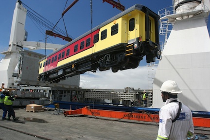 An executive rail coach is loaded onto the Safmarine Longa under the watchful eye of SafmarineMPV staff and crew