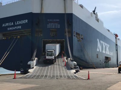 Tractor trailer being loaded onto Auriga Leader for export (Photo: Canaveral Port Authority)
