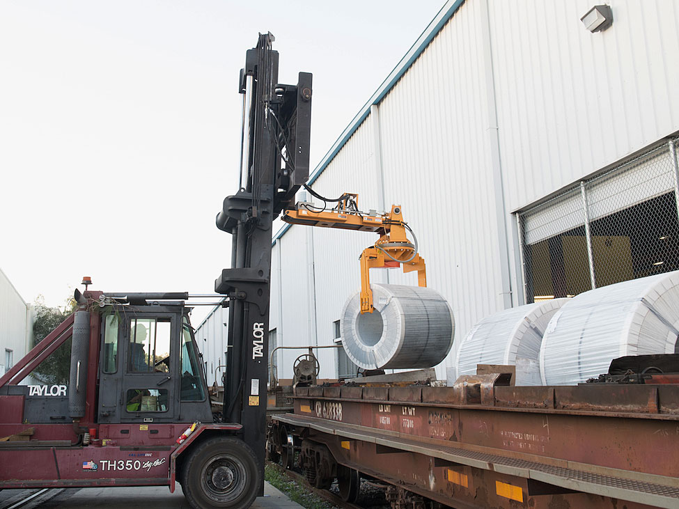MiTek receives the steel coils in batches of six or seven aboard each rail car