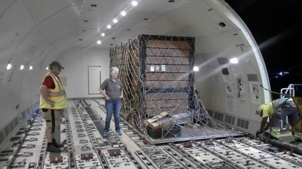 Crate loaded onto aircraft and secured into place
