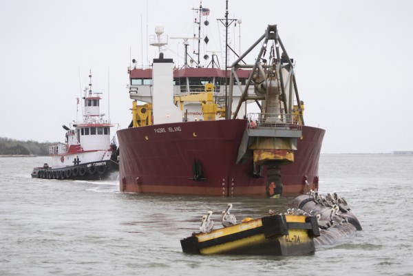 The container ship COSCO Glory (at right), with a capacity of 13,100 twenty-foot equivalent container units, passes the dredge Padre Island as it works the Savannah Harbor entrance channel. The U.S. Army Corps of Engineers marked the completion of outer harbor dredging as it reached the midpoint of the Savannah Harbor Expansion Project.