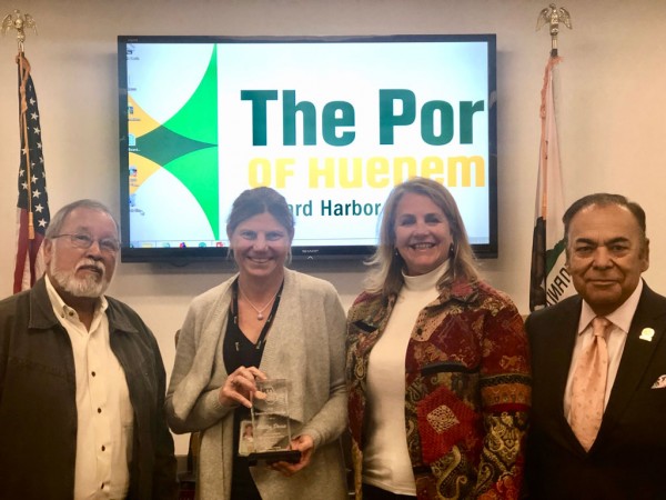 Vice President Jess Ramirez, Commissioner Mary Anne Rooney, and President Jess Herrera congratulate CEO & Port Director Kristin Decas (center left) on the VCSDA Award