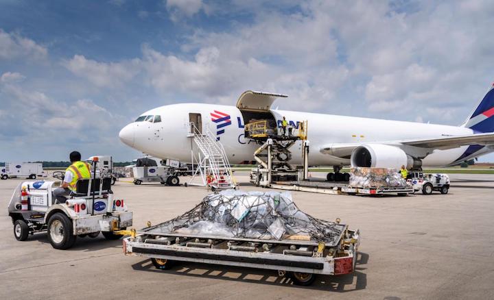 A DSV employee shuttles a load of cargo destined for Brazil on the new LATAM Star route from Huntsville International Airport. The weekly, direct international air cargo service is a collaboration between LATAM Group and DSV, based at HSV. Photo Credit: Mark Davis/DSV