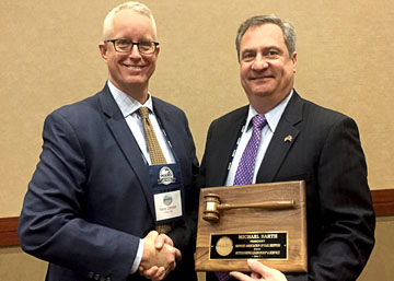 The new MARS President Harry Zander (left) is congratulated by outgoing president Michael Barth, who was honored for his leadership at the 2018 Winter Meeting in January.