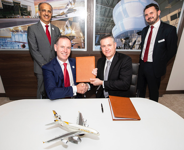 Abdul Khaliq Saeed, Chief Executive Officer, Etihad Airways Engineering and Tony Douglas, Group Chief Executive Officer, Etihad Aviation Group with Mark Brooks, Aircraft Commercial Global Support General Manager, Moog Inc and Peter Evans, Director Sales and Business Development at the Bahrain International Airshow