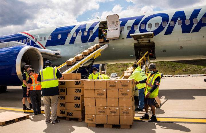 Crews work to unload a National Airlines cargo flight carrying critical medical supplies at Pittsburgh International Airport on April 25. (Photo by Beth Hollerich) 