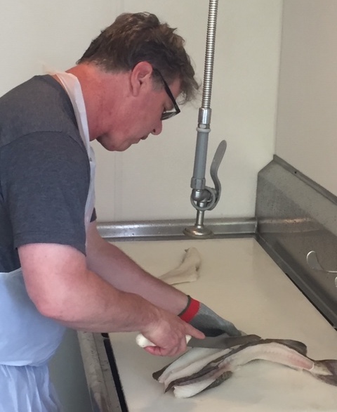 Senior inspector Scott Albrecht begins work on a sample whole cod at NSF International’s new seafood services program office located at the Port of Everett in Everett, Washington. 