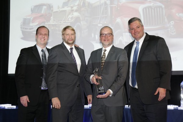 Elgin Industries President William Skok, second from right, receives the Navistar Diamond Supplier Award during a recent ceremony. Elgin has won the award, Navistar’s top honor for suppliers, twice since 2010.