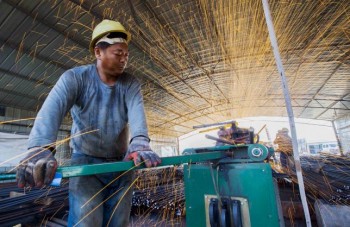 https://www.ajot.com/images/uploads/article/china-laborer-cutting-steel.jpg