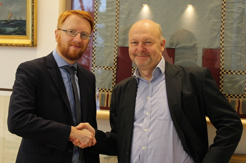 Richard Doherty from CIRM (left) and Aron Frank Sørensen from BIMCO (right) congratulate each other after finalizing the Standard on Software Maintenance of Shipboard Equipment text. 