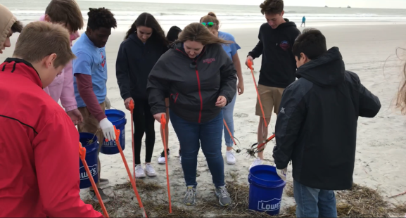 Students from Rockledge High School Maritime Studies Program sift through seaweed for trash (Photo: Canaveral Port Authority) 