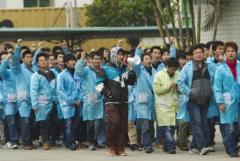  IBM workers shout slogans as they protest at an IBM factory in Shenzhen, Guangdong province, March 7, 2014. Credit: Reuters/Alex Lee
