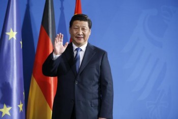 China's President Xi Jinping waves to media following a joint news conference with German Chancellor Angela Merkel after an agreement signing, at the Chancellery in Berlin March 28, 2014. 