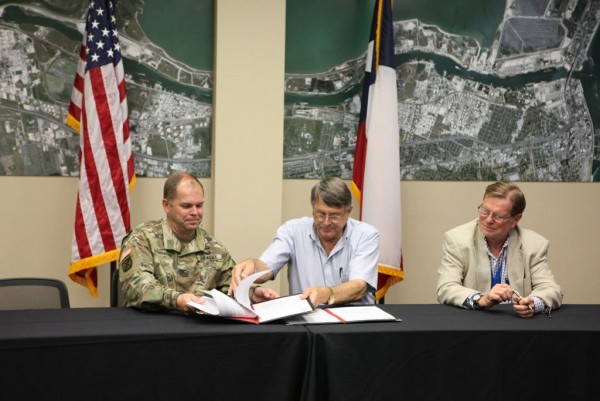 Col. Lars Zetterstrom, U.S. Army Corps of Engineers Galveston District commander, Charles W. Zahn, Jr., Chairman of the Port Corpus Christi Commission, and John LaRue, Port Corpus Christi Executive Director sign the MOU with port and corps staff in attendance.