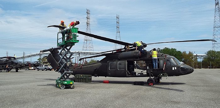 Workers for the 101st Airborne Division reassemble propeller gear and other parts on a UH-60 Black Hawk helicopter at JAXPORT