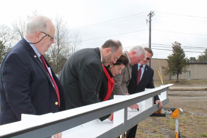 (Left to right) Town Council President Richard Welch, Commerce Secretary Stefan Pryor; Governor Gina Raimondo; Steve Olyha, CEO of Finlays and Steven King, Managing Director of the QDC sign the final beam for Finlays New Facility