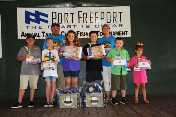 Back row left Port Freeport Commission Chairman Ravi Singhania, Executive Director/CEO Phyllis Saathoff; Front row left Yellow Fins 3rd Place Jason Hlavinka, Yellow Place 2nd Place Abigail Pillar, Yellow Fins 1st Place, Katelyn Dirzanowiski; Blue Fins 1st Place Reid Duske, Blue Fins 2nd Place Ryan Dirzanowiski, and Blue Fins 3rd Place Isabella Hlavinka.
