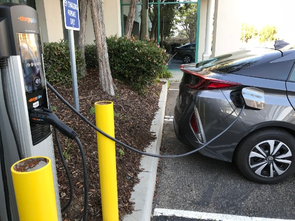 A hybrid vehicle plugs into one of the Port of Hueneme’s new electric vehicle charging stations.