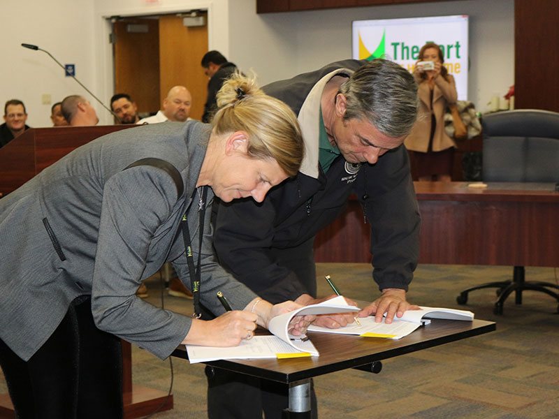 Kristin Decas, CEO and Port Director, and Tony Skinner, President of the IBEW Local 952, sign the historic agreement