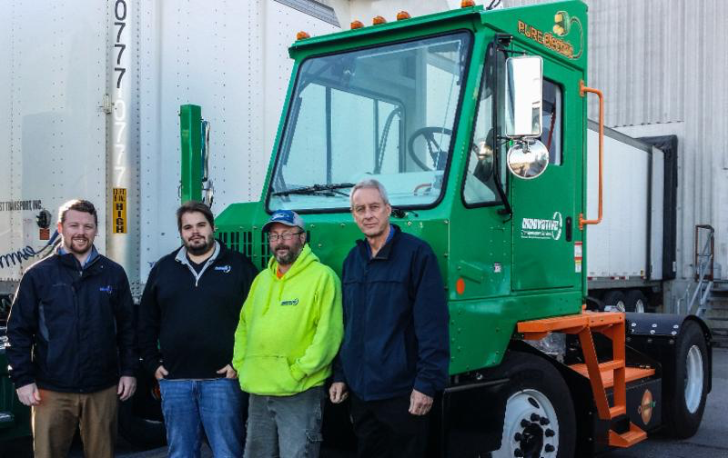 Innovative Transportation Services (ITS) with their new Orange EV T-Series pure-electric terminal truck. From left: Bill Loupee, Vice President of both ITS and TCS (Transportation and Consolidation Services, Inc.); James Hotnich, Dispatch Manager; Owen Owens, Driver; and Dave Harper, President of ITS.