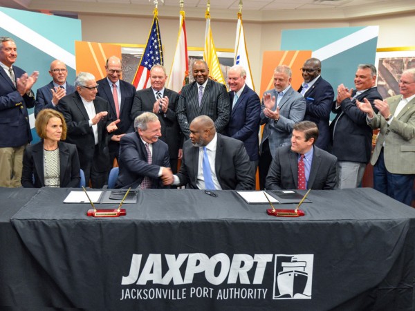 JAXPORT CEO Eric Green (center right) and SSA Conventional President Mark Knudsen shake hands during today's ceremony