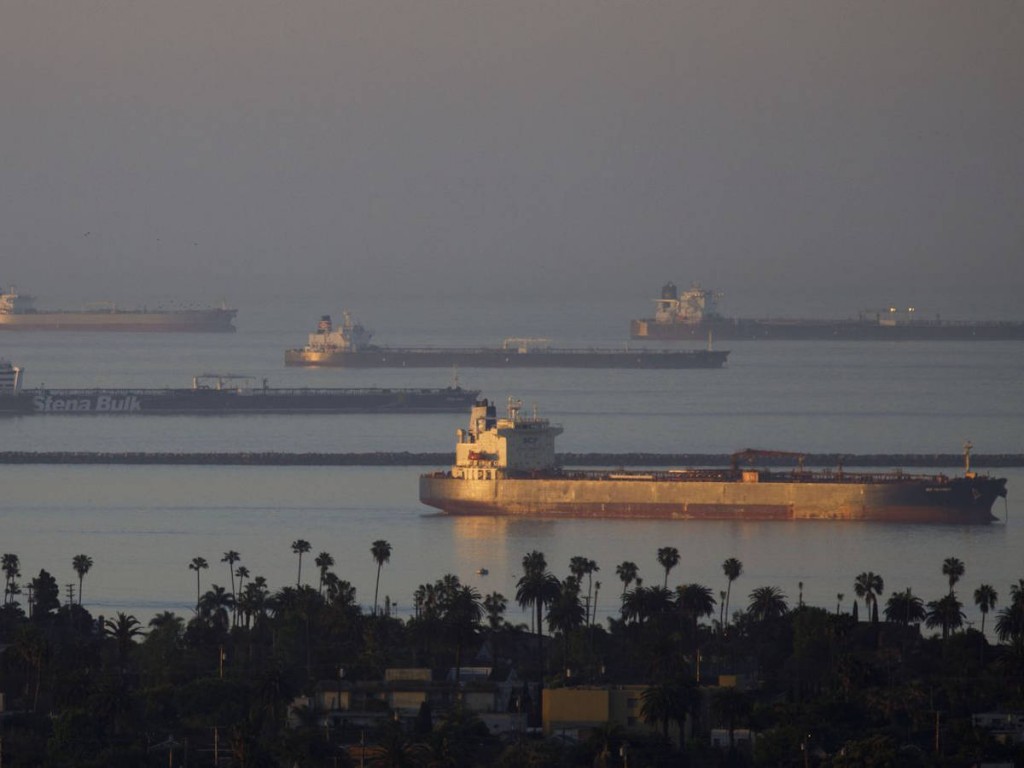 Shipping vessels and oil tankers sit anchored outside the Port of Long Beach and Port of Los Angeles in California on April 24.Photographer: Patrick T. Fallon/Bloomberg
