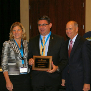 Port Managing Director of Environmental Affairs and Planning Rick Cameron accepts the award for Environmental Improvement from AAPA Chair Kristin Decas and AAPA CEO and President Kurt Nagle.