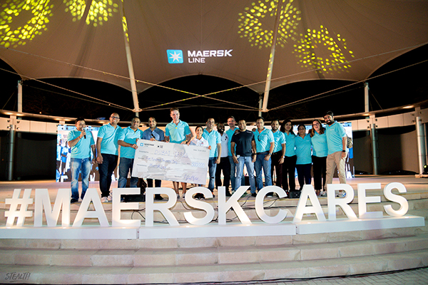 Maersk Line UAE staff and customers with the cheque of AED 500,000 raised with this initiative.