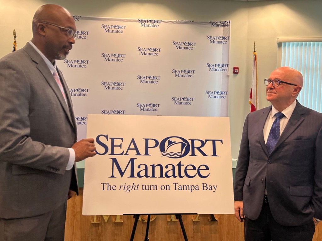 Reggie Bellamy, chairman of the Manatee County Port Authority, left, unveils the SeaPort Manatee logo along with Carlos Buqueras, the dynamic seaport’s executive director.