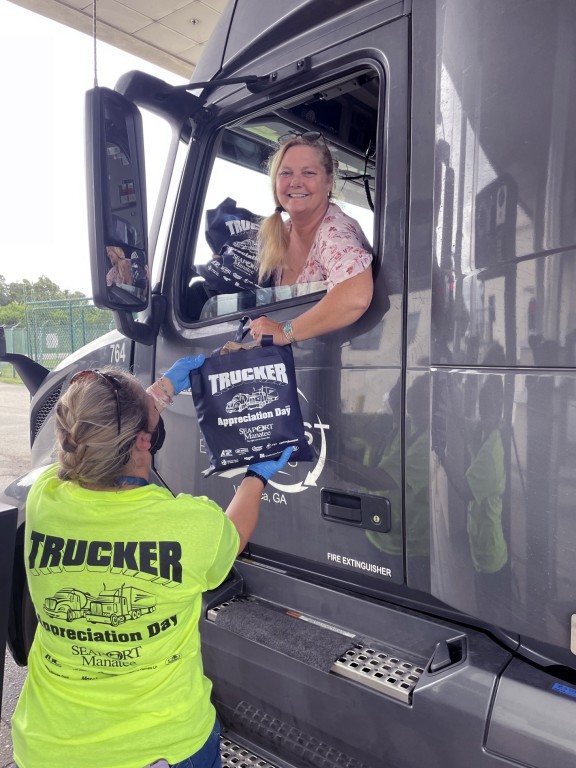Lisa Rogers Orozco, who drives for Villa Rica, Georgia-based East-West Express Inc., smilingly accepts a goody bag as Port Manatee thanks professional drivers with its sixth annual Trucker Appreciation Day.