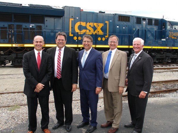Those gathered for announcement of the Queen City Express include, from left: North State Ports Authority Executive Director Paul J. Cozza ; Michael J. Ward, chairman and chief executive officer of CSX Corp.; North Carolina Gov. Pat McCrory; North Carolina Secretary of Transportation; Tom Adams, chairman of the board, North Carolina State Ports Authority.