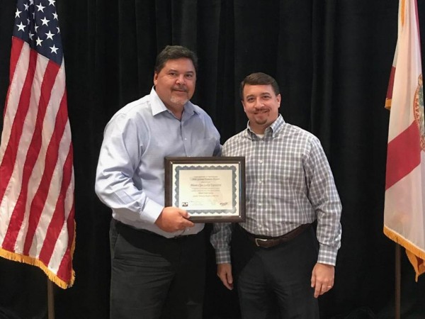 Nelson Mejias, OPF Airport Operations Supervisor, accepts the award for General Aviation Airport of the Year from Aaron Smith, FDOT State Aviation Manager, at the CFASPP Conference in Tampa.