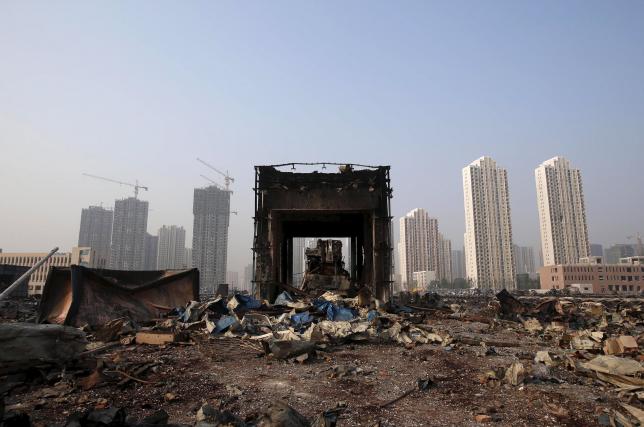 A damaged building is seen among debris at the site of Wednesday night's explosions in Binhai new district of Tianjin, China, August 15, 2015. Reuters/China Daily CHINA OUT. 