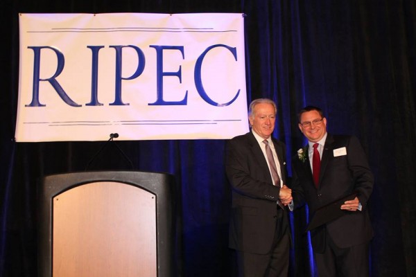RIPEC's Executive Dir. John Simmons presents the Gary S. Sasse Award to Quonset's Managing Dir. Steven King 