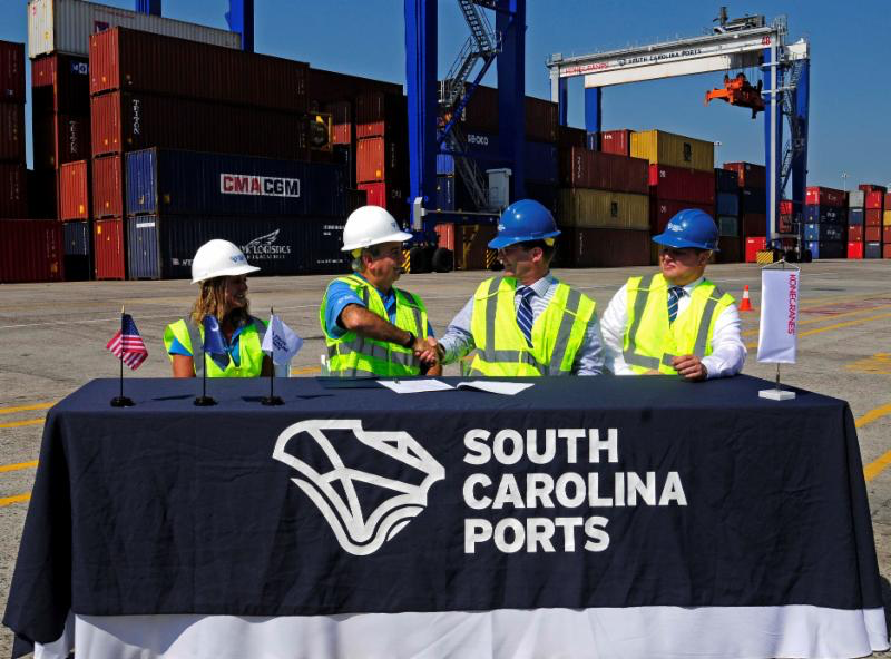 From left, SC Ports Authority Senior Vice President of Operations and Terminals Barbara Melvin and CEO Jim Newsome celebrate the purchase of 26 rubber-tired gantry cranes with Konecranes representatives Mika Mahlberg, Executive Vice President of Port Solutions and Jussi Suhonen, Regional Sales Director Americas, Port Solutions.