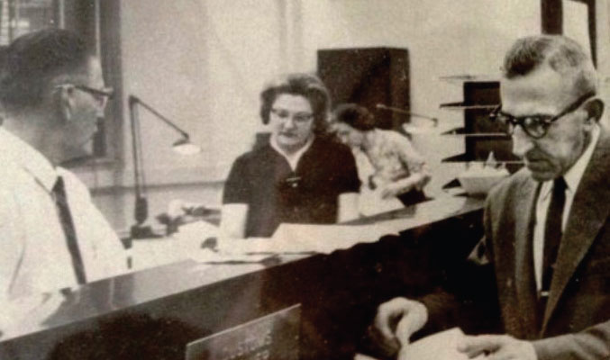 In the early days of his customs brokerage business, Sam Shapiro (right) personally handles a filing at the U.S. Custom House in Baltimore.