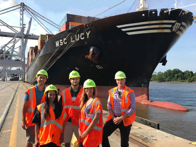 UWL Employees pose in front of the container vessel MSC Lucy at the Port of Savannah. From left to right: Johnny Maiden, Latesha Mosley, Dave Pycraft (UWL Savannah Tour Guide), Adrienne Parrish, Celestino