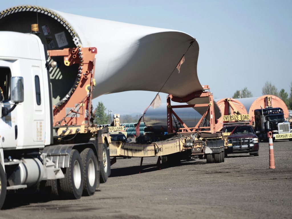 A convoy of Totran Transportation Services trucks carries 250-foot-long blades from the Port of Vancouver USA